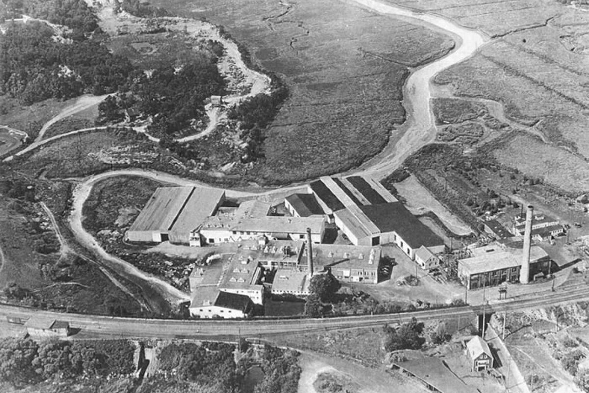 Aerial photo of Woolen Mill (1938). Train tracks in front is the same route that the Greenbush line will use. Great Esker Park in upper left hand corner and back river in the upper right. Image provided by: Jodi Purdy-Quinlan, Vice Chairman of the Weymouth Historical Commission