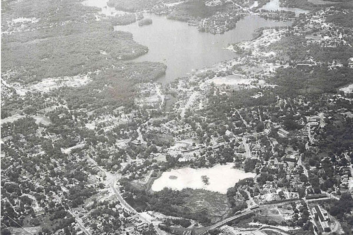 Aerial photo of East Weymouth. White area in forground is a sand pit. The sand pit is now occupied by the Lawrence W. Pingree Primary School. Large area of water at the top of the photo is Whitman's Pond. Image provided by: Jodi Purdy-Quinlan, Vice Chairman of the Weymouth Historical Commission