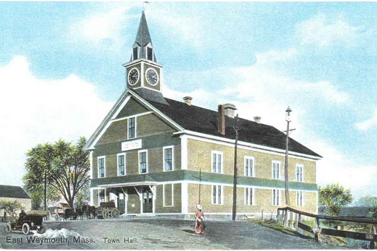 Old Town Hall building, East Weymouth, MA (postcard). First Town Hall - Built in 1852 near the corner of Middle & Washington Streets, moved in 1906-7 to Pleasant Street at the at the Gloria Burke Teen Center Location. The building was destroyed by fire, May 27, 1914. Image provided by: Jodi Purdy-Quinlan, Vice Chairman of the Weymouth Historical Commission