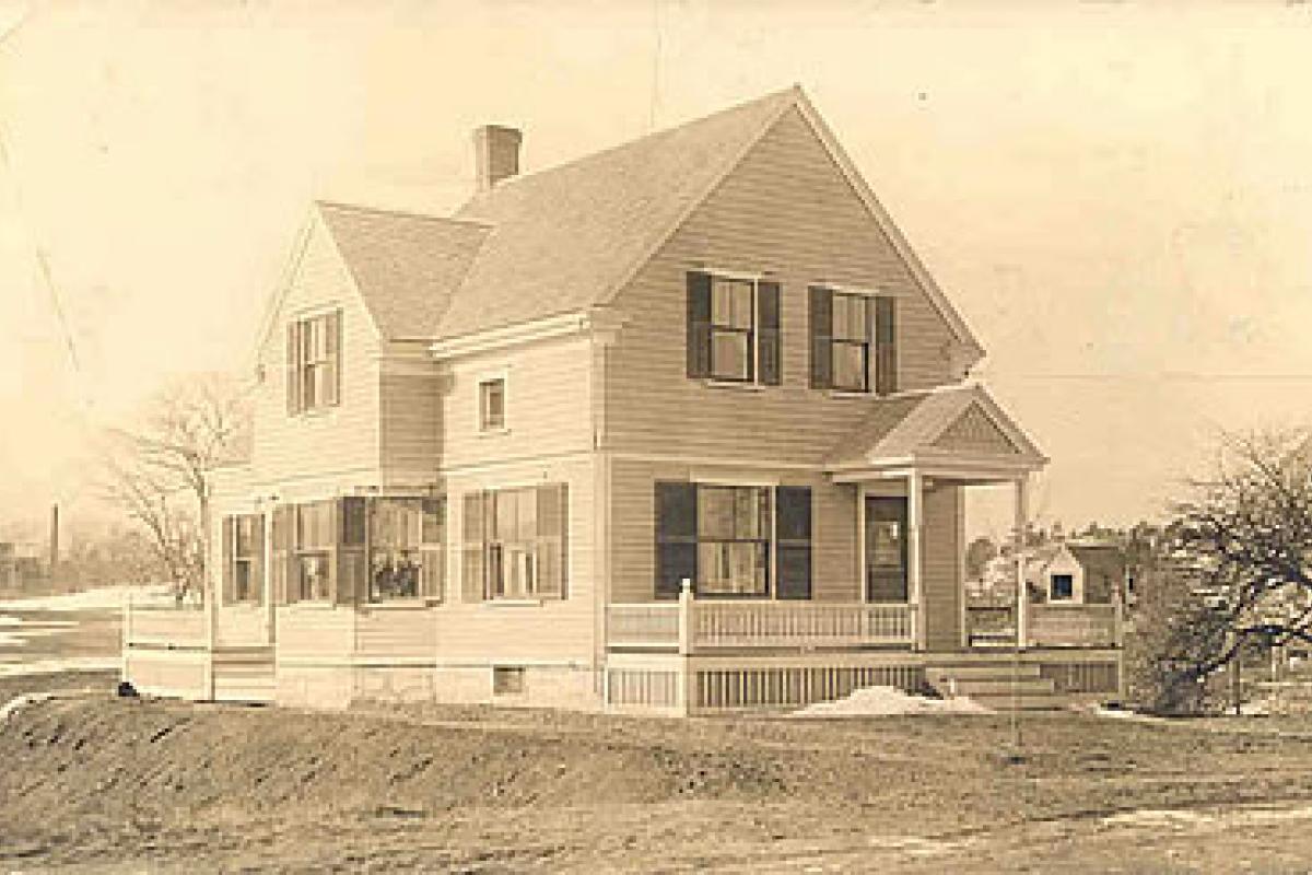 Photo of Cowing House on 1075 Commercial Street, East Weymouth. The area behind the house was a farm. The Cowing Family donated the land behind this house to the town and the North High School was built there. The building is still there today. Image provided by the William and Elaine Pepe postcard collection.